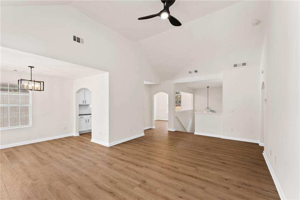 5805 Marbut Road Lithonia, GA 30058 - Photo 14 of 46 an empty room with wooden floor cabinet and windows