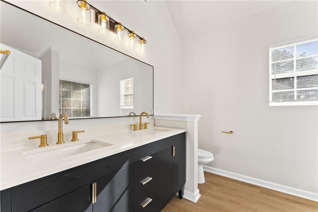 5805 Marbut Road Lithonia, GA 30058 - Photo 25 of 46 a bathroom with a sink a toilet and a mirror