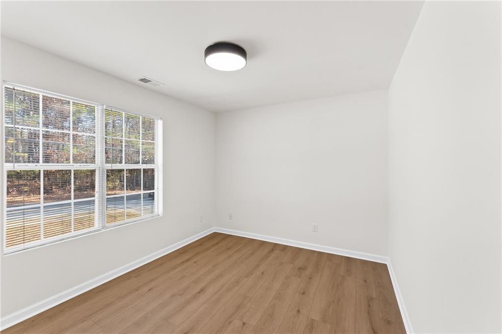 5805 Marbut Road Lithonia, GA 30058 - Photo 27 of 46 a view of empty room with wooden floor and fan