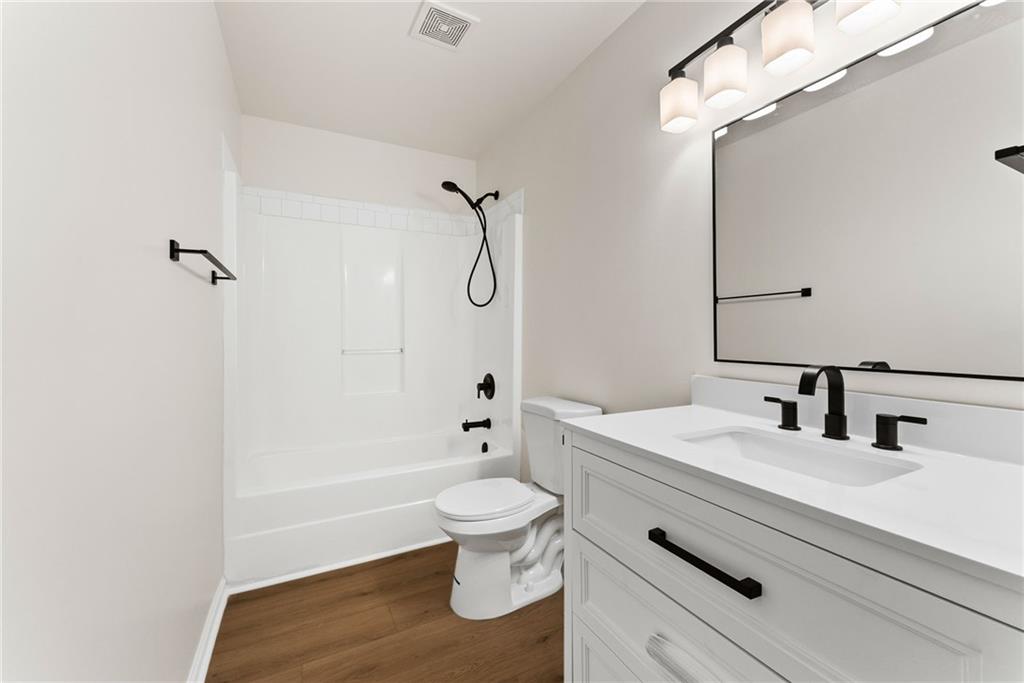 5805 Marbut Road Lithonia, GA 30058 - Photo 29 of 46 a bathroom with a sink a toilet and a mirror