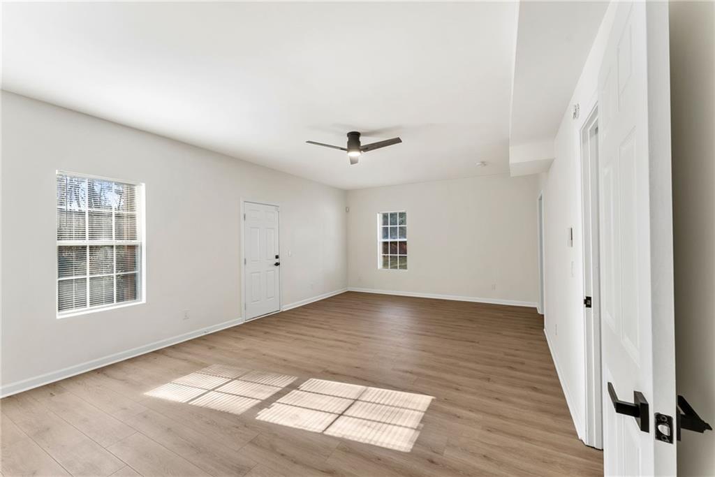 5805 Marbut Road Lithonia, GA 30058 - Photo 31 of 46 an empty room with windows and ceiling fan