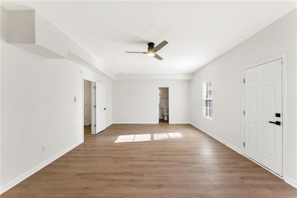 5805 Marbut Road Lithonia, GA 30058 - Photo 33 of 46 a view of an empty room with wooden floor and a ceiling fan