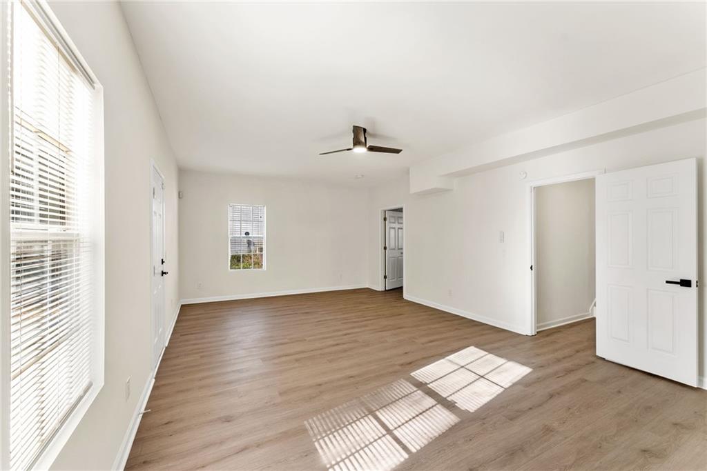 5805 Marbut Road Lithonia, GA 30058 - Photo 35 of 46 a view of an empty room with wooden floor and a window