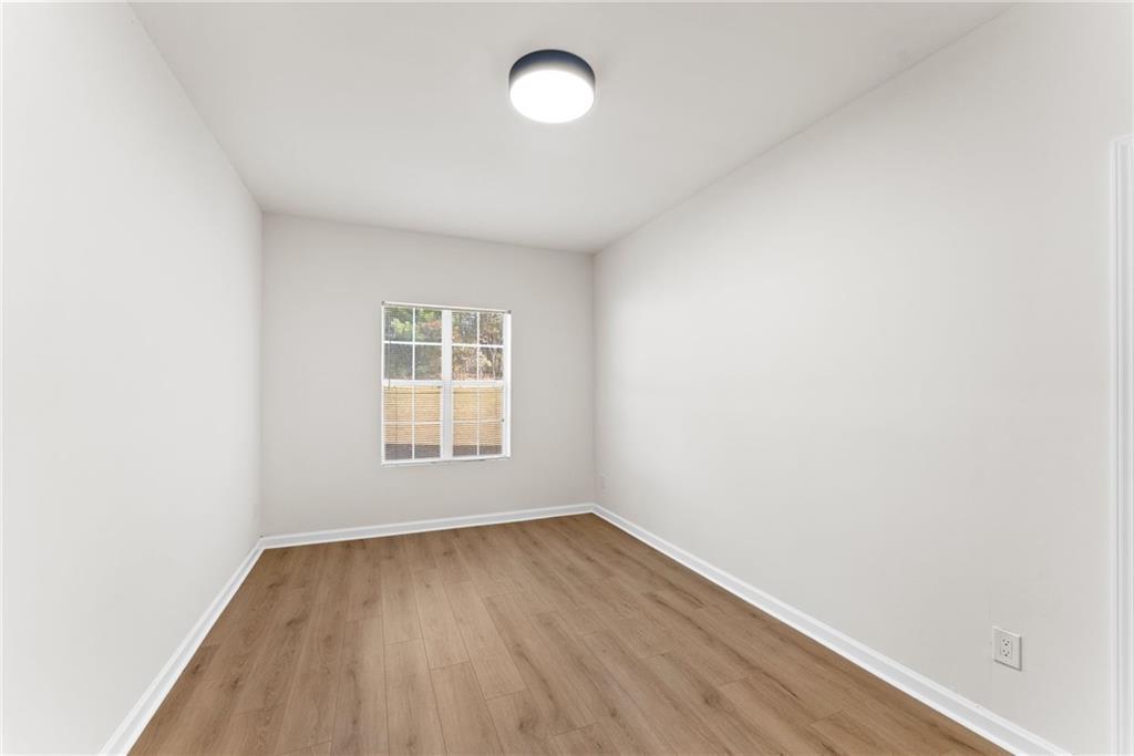 5805 Marbut Road Lithonia, GA 30058 - Photo 37 of 46 an empty room with wooden floor and windows