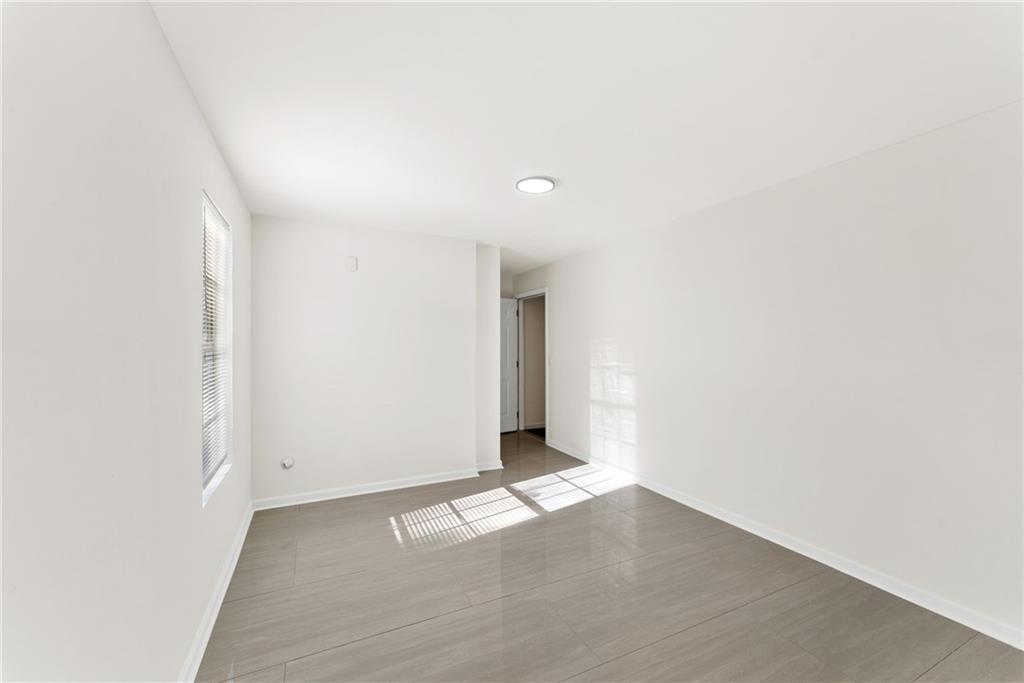 5805 Marbut Road Lithonia, GA 30058 - Photo 41 of 46 a view of a livingroom with wooden floor and window