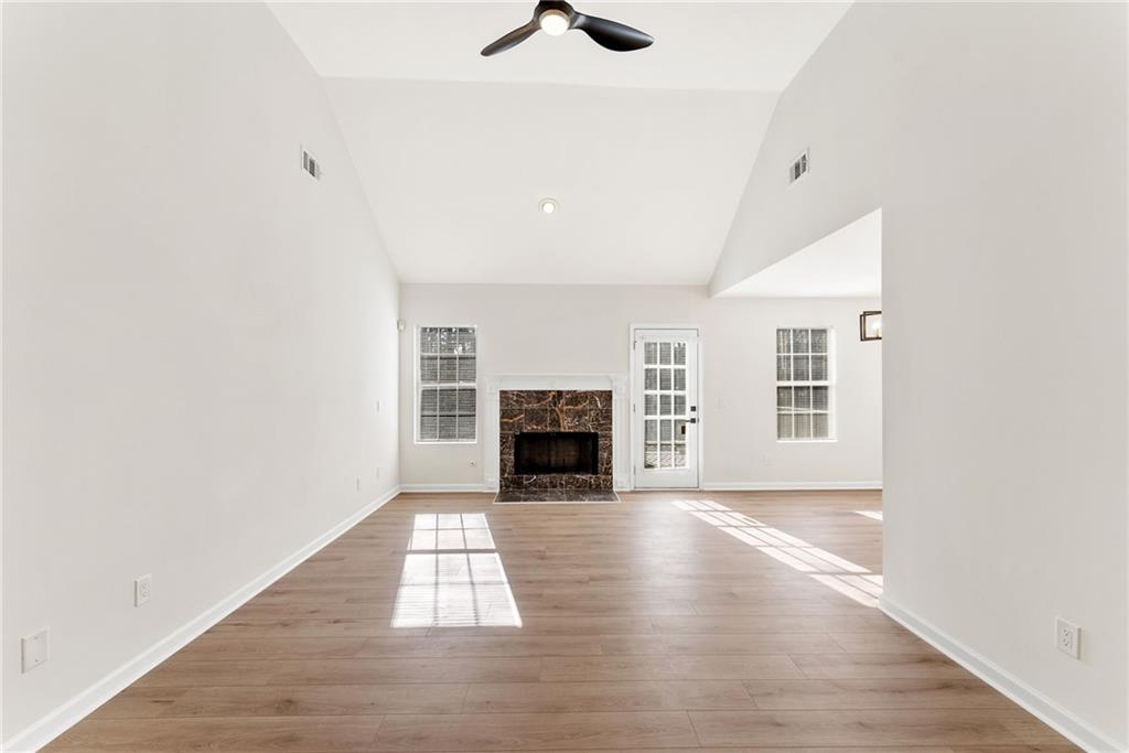 5805 Marbut Road Lithonia, GA 30058 - Photo 7 of 46 an empty room with windows and fireplace