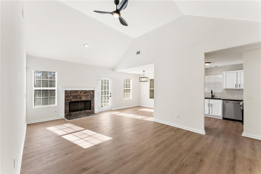 5805 Marbut Road Lithonia, GA 30058 - Photo 8 of 46 a view of empty room with a fireplace and wooden floor