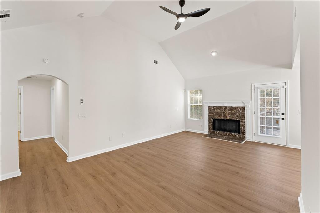 5805 Marbut Road Lithonia, GA 30058 - Photo 9 of 46 a view of empty room with wooden floor and fireplace