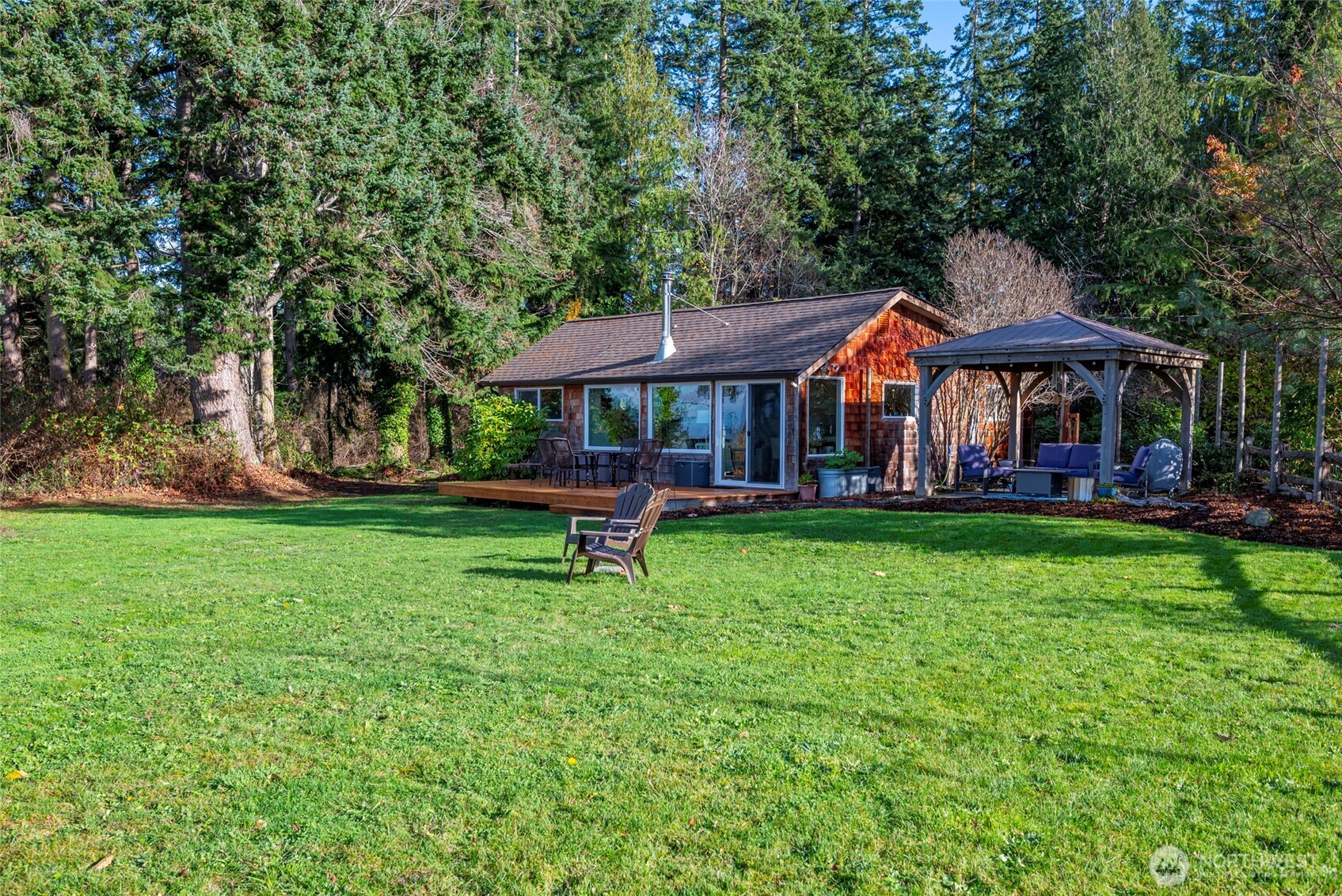 5222 East Harbor Road Freeland, WA 98249 - Photo 11 of 39 a view of a house with a yard table and chairs