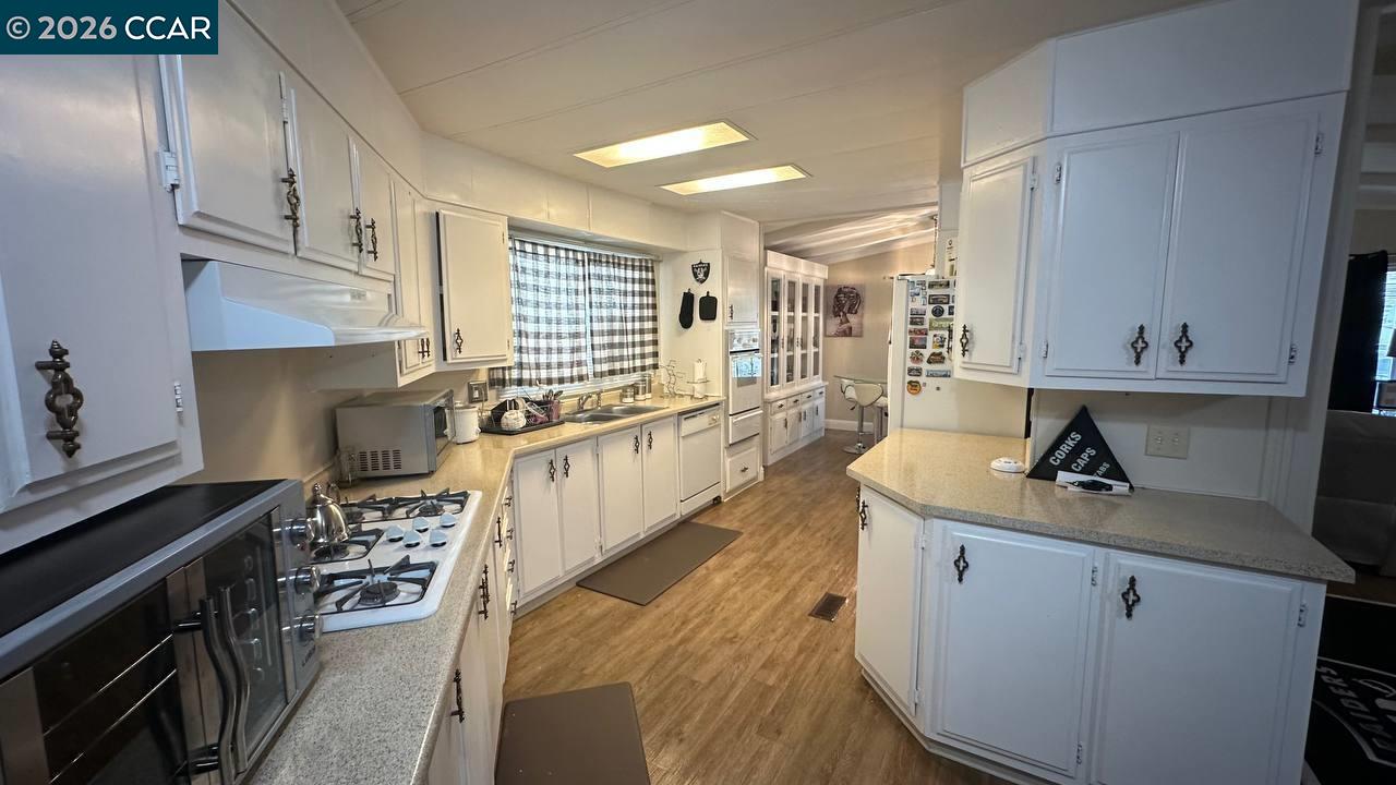 367 Ravine Circle Rancho Cordova, CA 95670 - Photo 13 of 21 a kitchen with a stove a sink and a refrigerator