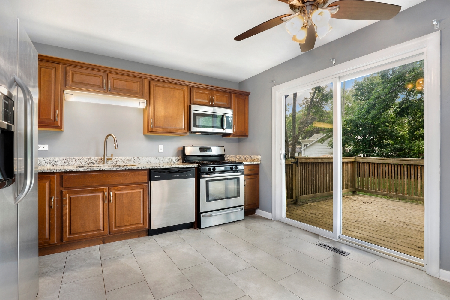 231 West 35th Street Steger, IL 60475 - Photo 5 of 17 a kitchen with stainless steel appliances granite countertop a stove sink and cabinets
