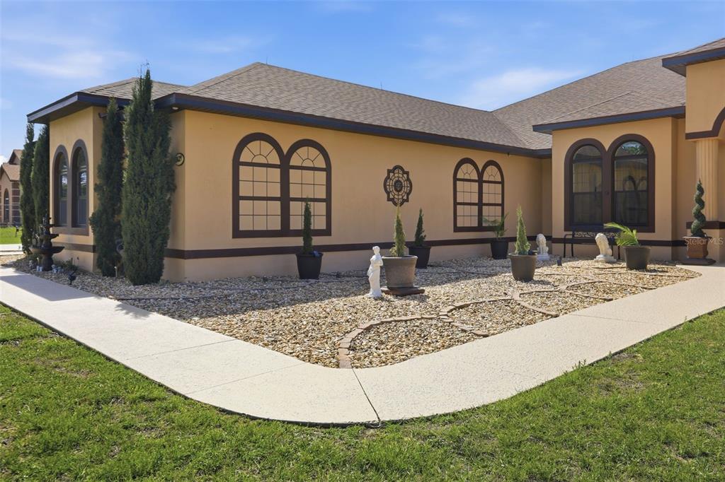 13429 Montevista Road Clermont, FL 34711 - Photo 7 of 89 a front view of a house with garden
