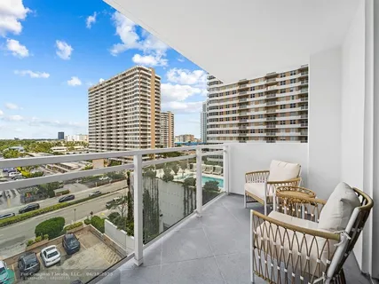 a balcony with furniture and city view