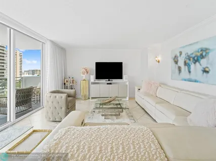 a bedroom with a large bed and a flat screen tv