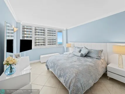 a spacious bedroom with a bed and a couch