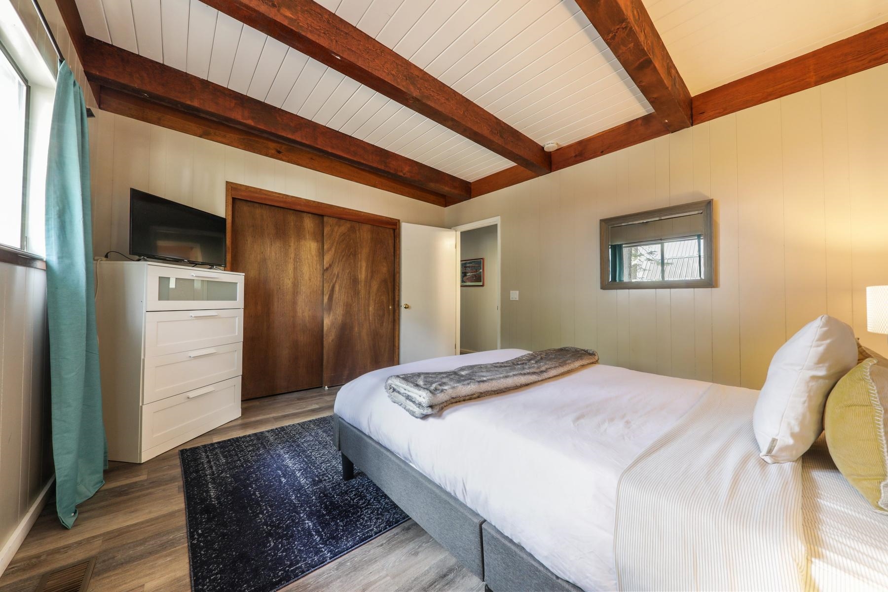 5656 Victoria Road Carnelian Bay, CA 96140 - Photo 18 of 28 a bedroom with a bed and a dresser