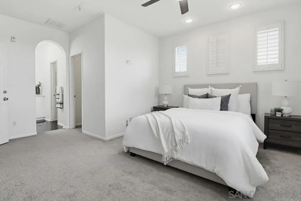 1293 Fools Gold Way, Unit 3 Chula Vista, CA 91913 - Photo 12 of 28 a spacious bedroom with a bed and a night stand