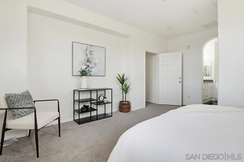 1293 Fools Gold Way, Unit 3 Chula Vista, CA 91913 - Photo 14 of 28 a bedroom with a bed a table and chair