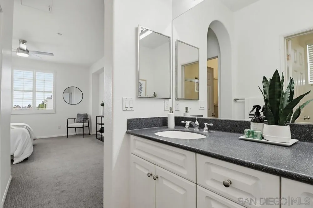 1293 Fools Gold Way, Unit 3 Chula Vista, CA 91913 - Photo 15 of 28 a bathroom with double vanity sinks a mirror and a window