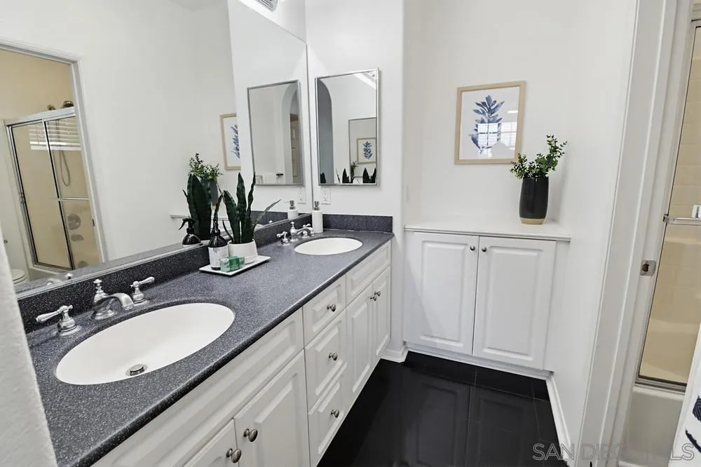 1293 Fools Gold Way, Unit 3 Chula Vista, CA 91913 - Photo 16 of 28 a bathroom with a double vanity sink and a mirror