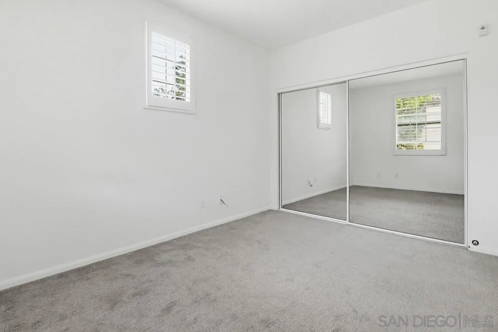 1293 Fools Gold Way, Unit 3 Chula Vista, CA 91913 - Photo 19 of 28 an empty room with windows and closet