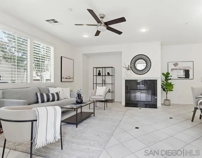 1293 Fools Gold Way, Unit 3 Chula Vista, CA 91913 - Photo 2 of 28 a living room with furniture a clock and a fireplace