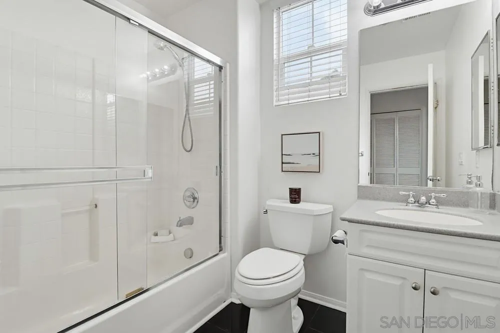 1293 Fools Gold Way, Unit 3 Chula Vista, CA 91913 - Photo 21 of 28 a bathroom with a granite countertop sink toilet and shower