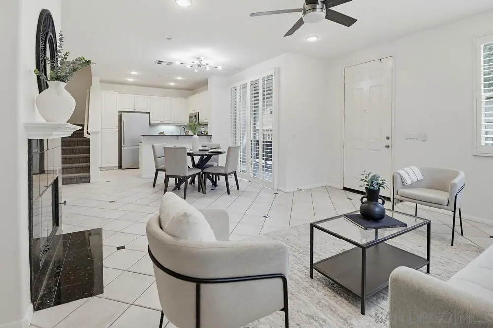 1293 Fools Gold Way, Unit 3 Chula Vista, CA 91913 - Photo 5 of 28 a living room with furniture a rug and white walls