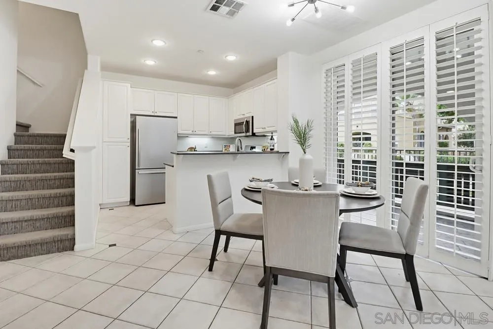1293 Fools Gold Way, Unit 3 Chula Vista, CA 91913 - Photo 6 of 28 a kitchen with a table chairs and a refrigerator