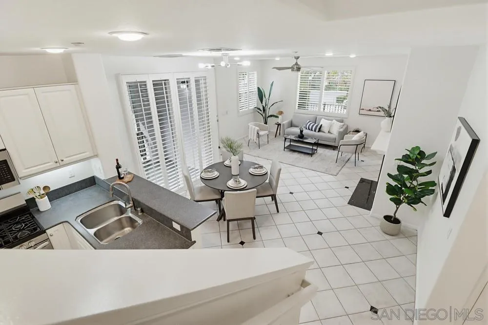 1293 Fools Gold Way, Unit 3 Chula Vista, CA 91913 - Photo 9 of 28 a living room with patio furniture and a large window