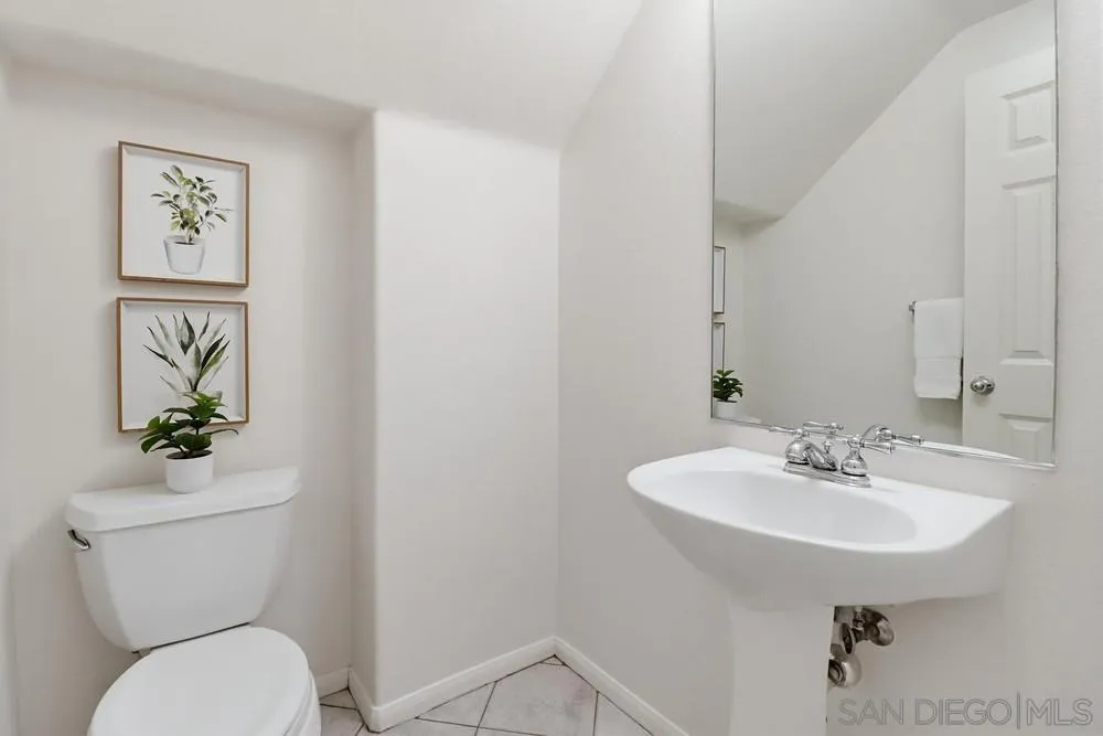 1293 Fools Gold Way, Unit 3 Chula Vista, CA 91913 - Photo 10 of 28 a bathroom with a toilet sink and mirror