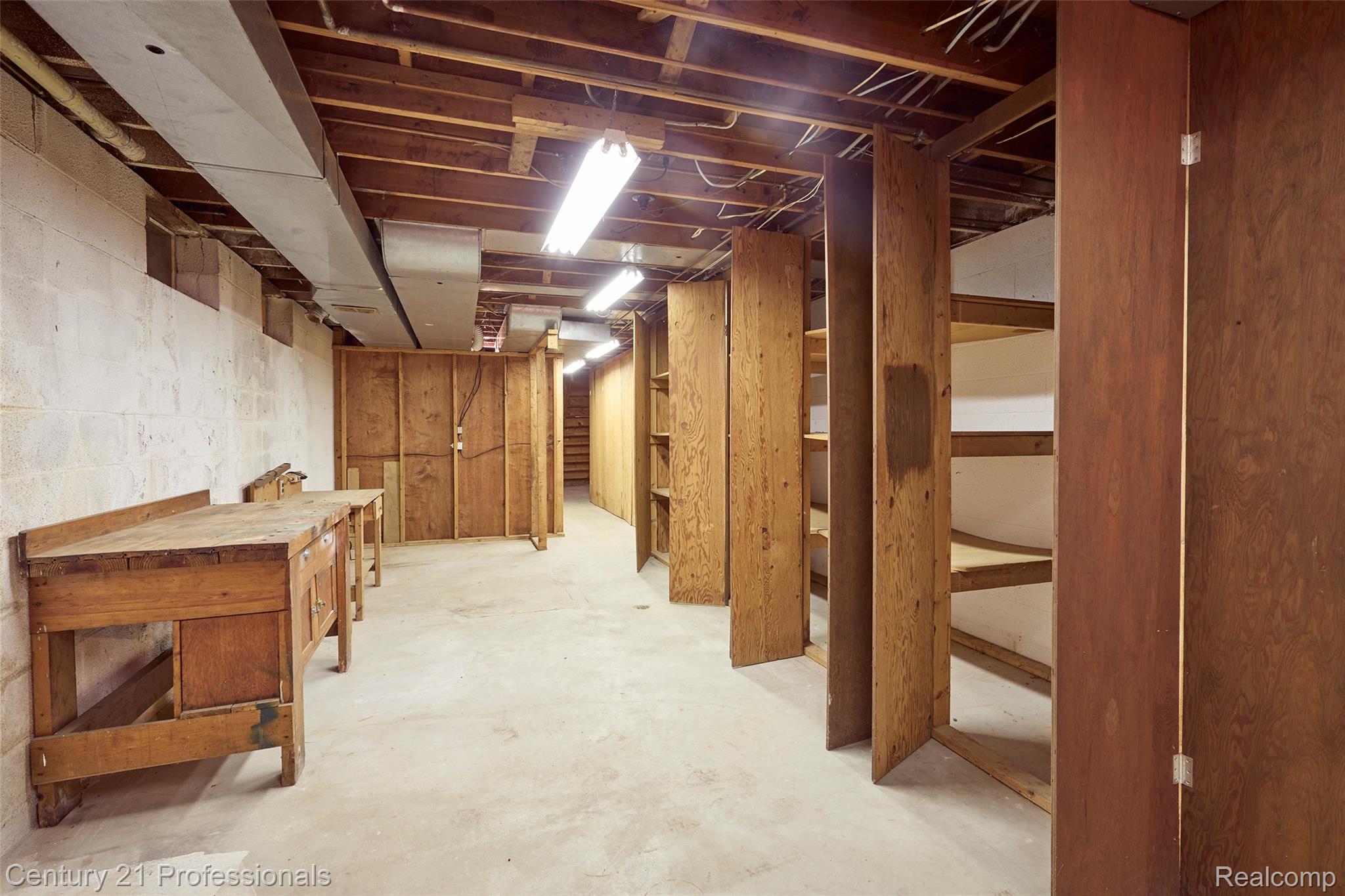303 East Snell Road Rochester, MI 48306 - Photo 40 of 45 basement work area with wall of cabinet storage