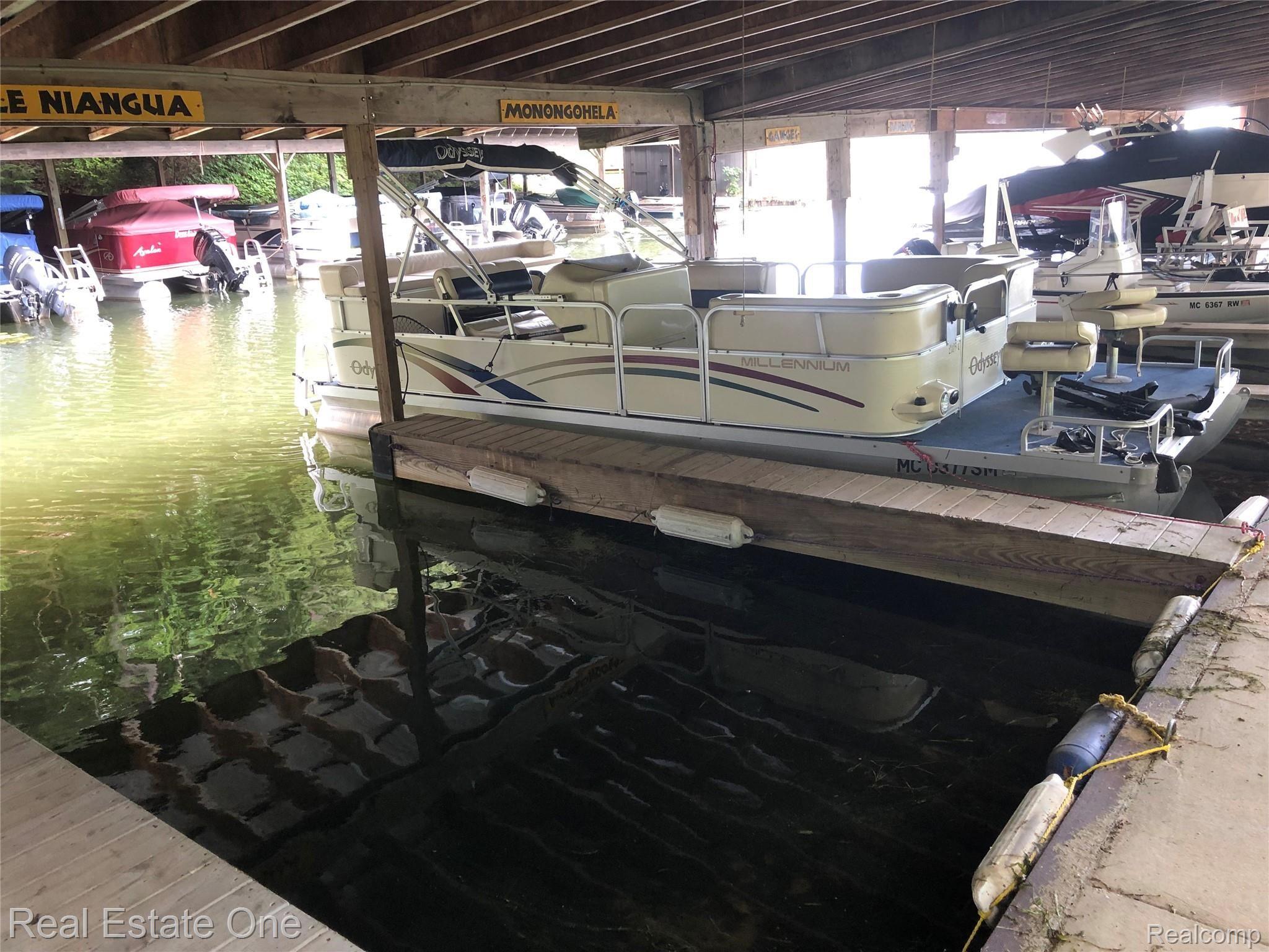 2722 Piney Ridge Road Ludington, MI 49431 - Photo 22 of 64 Two pontoon sized covered boat slips to store watercraft for the summer.