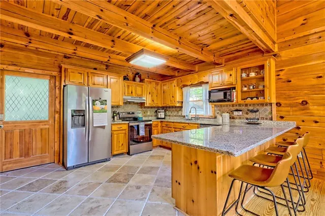 a view of a kitchen with a sink and cabinets
