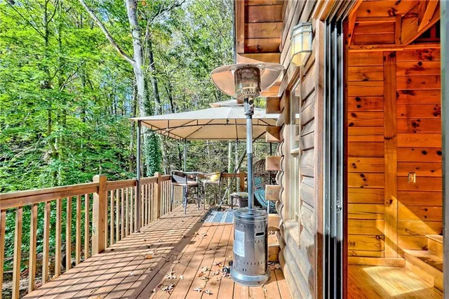 a view of balcony with wooden floor and outdoor seating