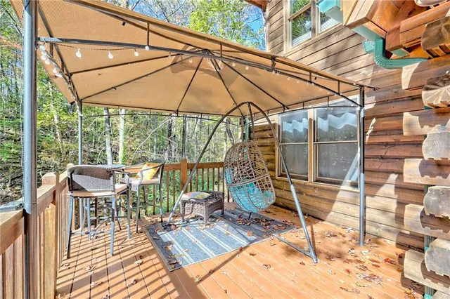 a view of balcony with wooden floor and chairs
