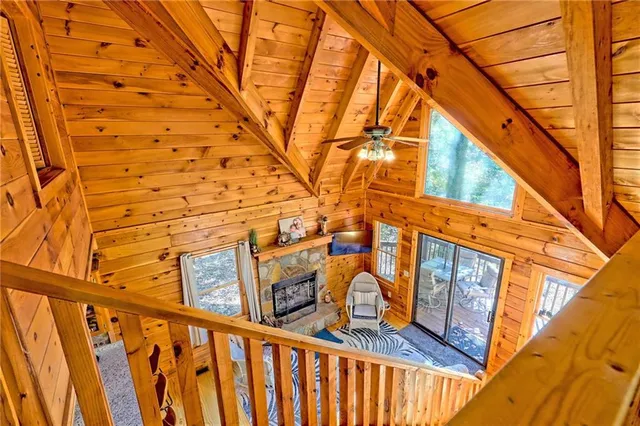 a view of a brick house with wooden fence and floor