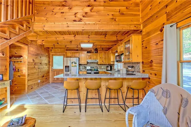a living room with blue lights with furniture and wooden floor