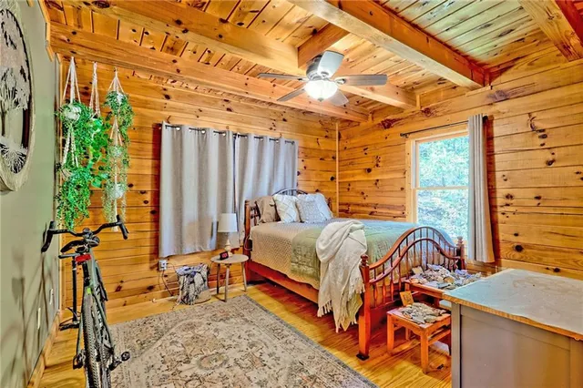 a bedroom with a bed next to a window