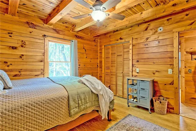 a bed sitting in a bedroom next to a window
