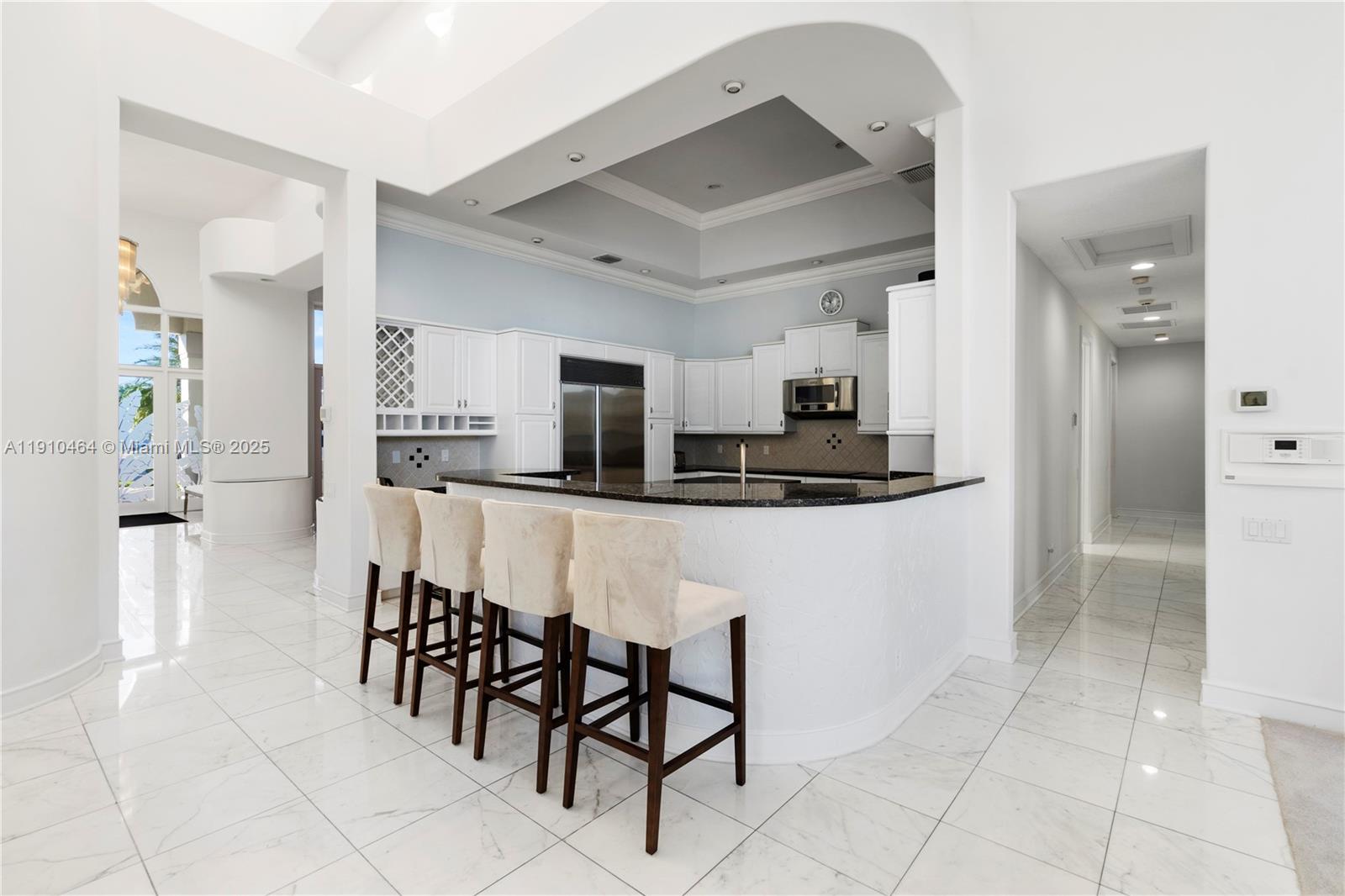 2939 Paddock Lane Weston, FL 33331 - Photo 15 of 59 a kitchen with stainless steel appliances kitchen island granite countertop a refrigerator and cabinets