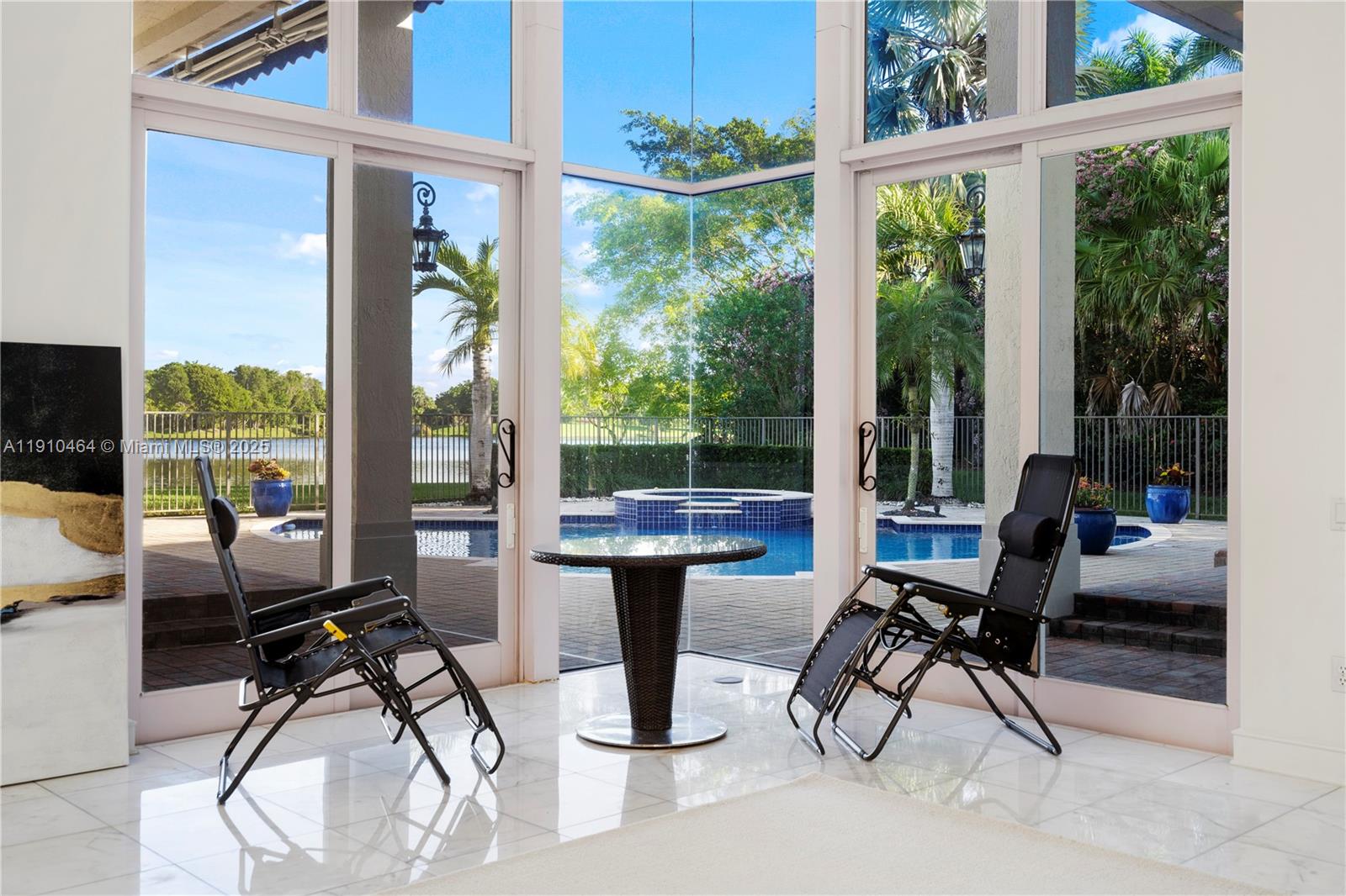 2939 Paddock Lane Weston, FL 33331 - Photo 19 of 59 a dining room with furniture water view and a floor to ceiling window