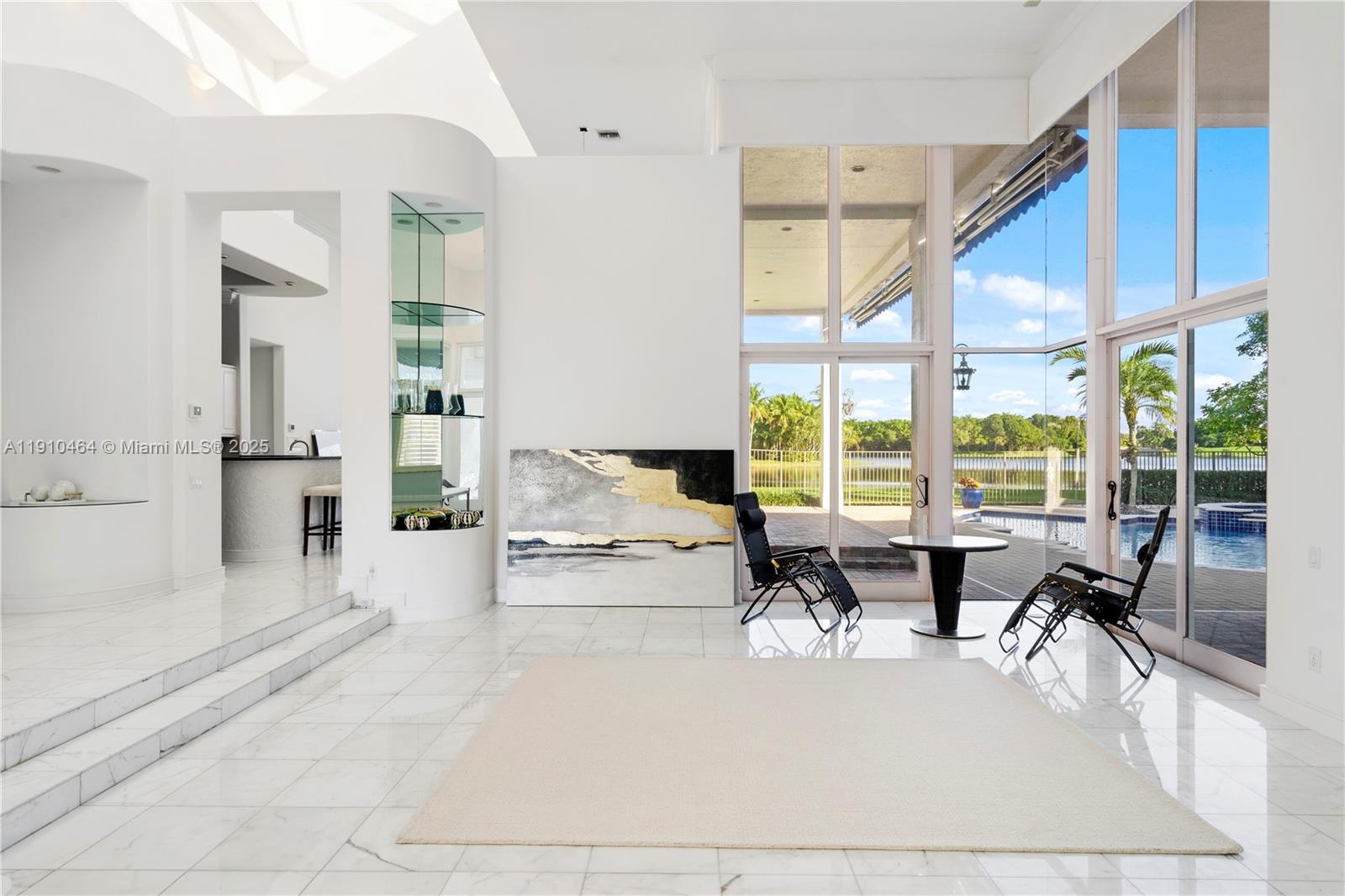 2939 Paddock Lane Weston, FL 33331 - Photo 20 of 59 a living room with furniture large windows a rug and white walls