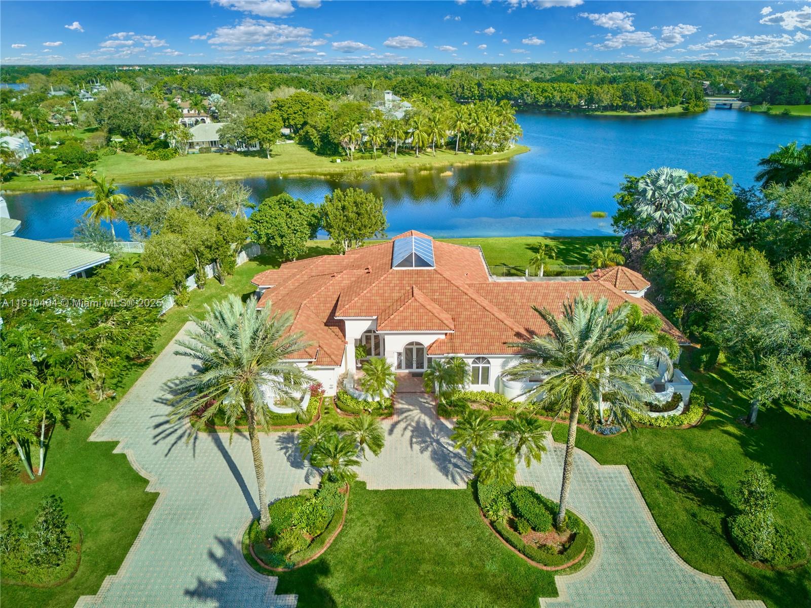 2939 Paddock Lane Weston, FL 33331 - Photo 2 of 59 an aerial view of a house with a yard and lake view