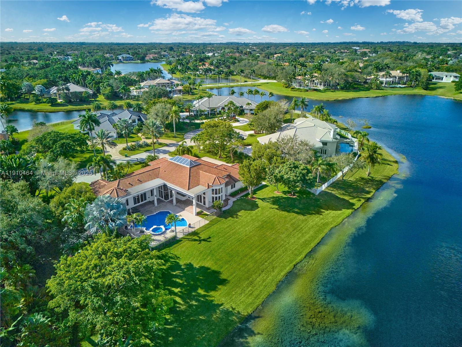 2939 Paddock Lane Weston, FL 33331 - Photo 3 of 59 an aerial view of a house with a garden and lake view