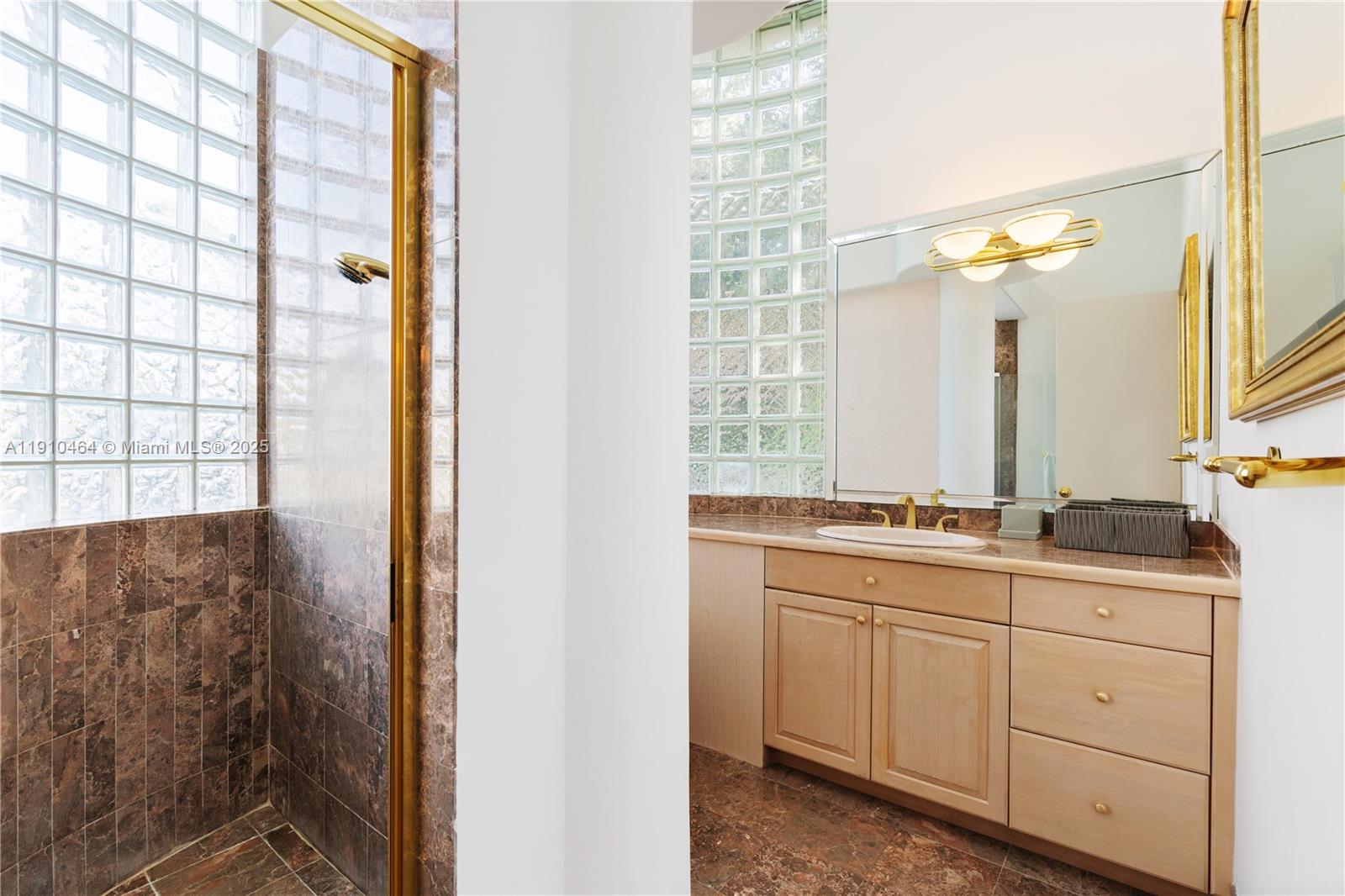 2939 Paddock Lane Weston, FL 33331 - Photo 37 of 59 a bathroom with a double vanity sink a mirror and next to a window