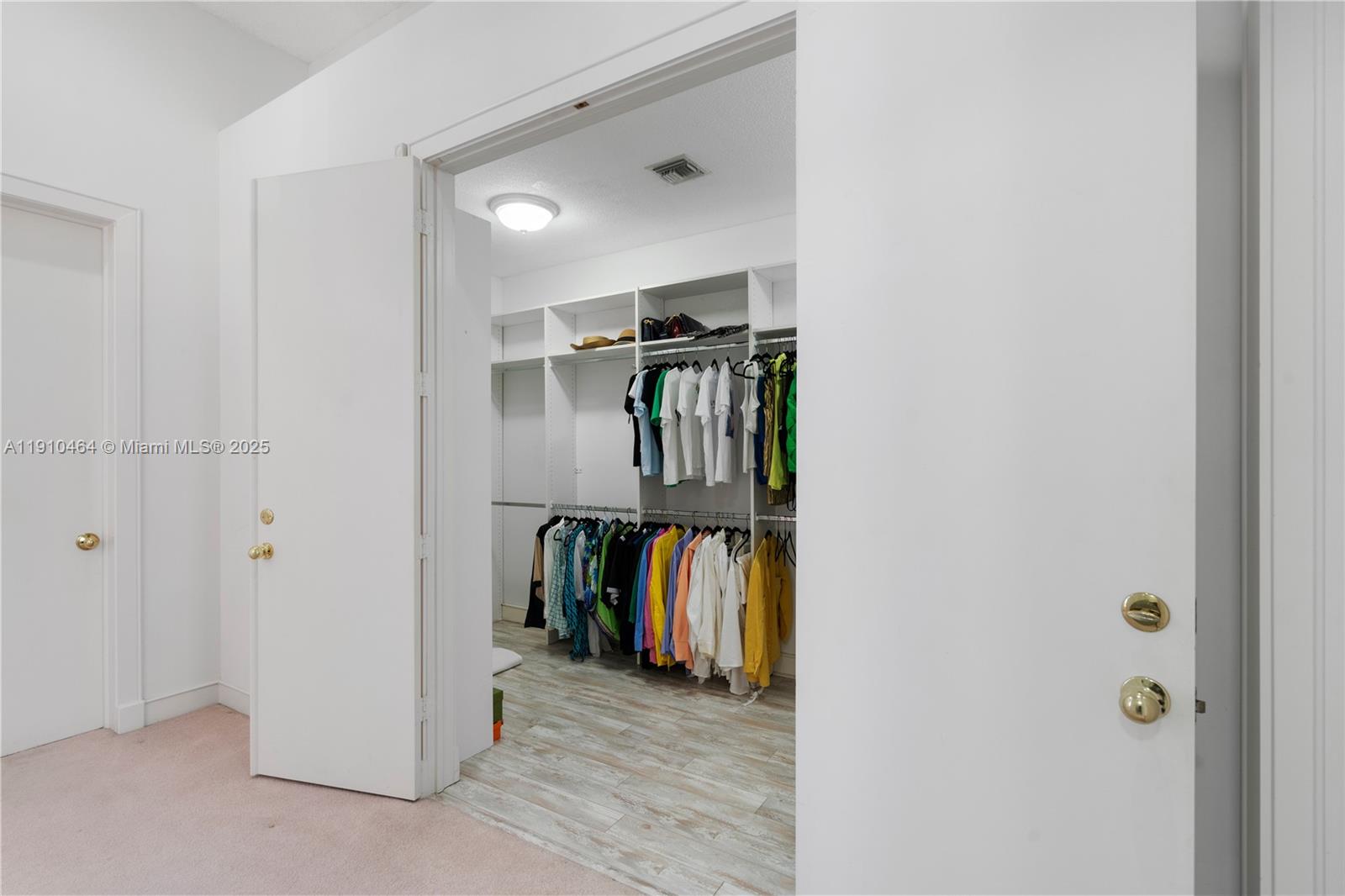 2939 Paddock Lane Weston, FL 33331 - Photo 39 of 59 a view of walk in closet with clothes and shoes