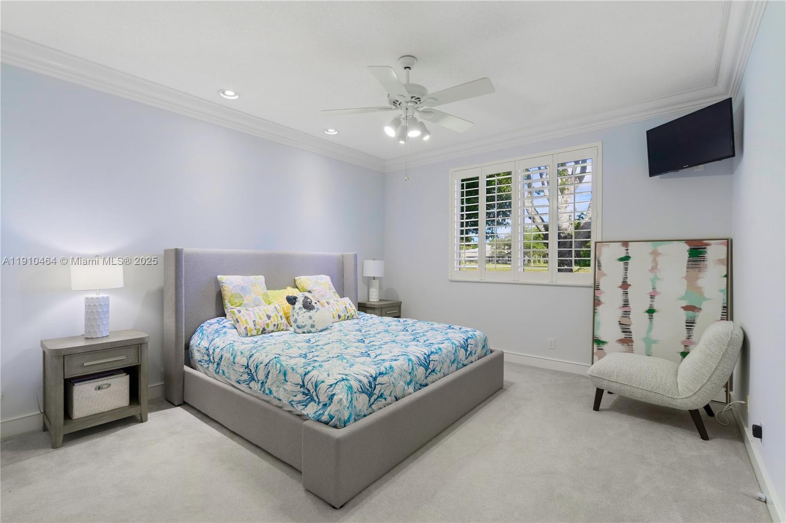 2939 Paddock Lane Weston, FL 33331 - Photo 42 of 59 a bedroom with a bed a couch and a flat tv screen on a dresser