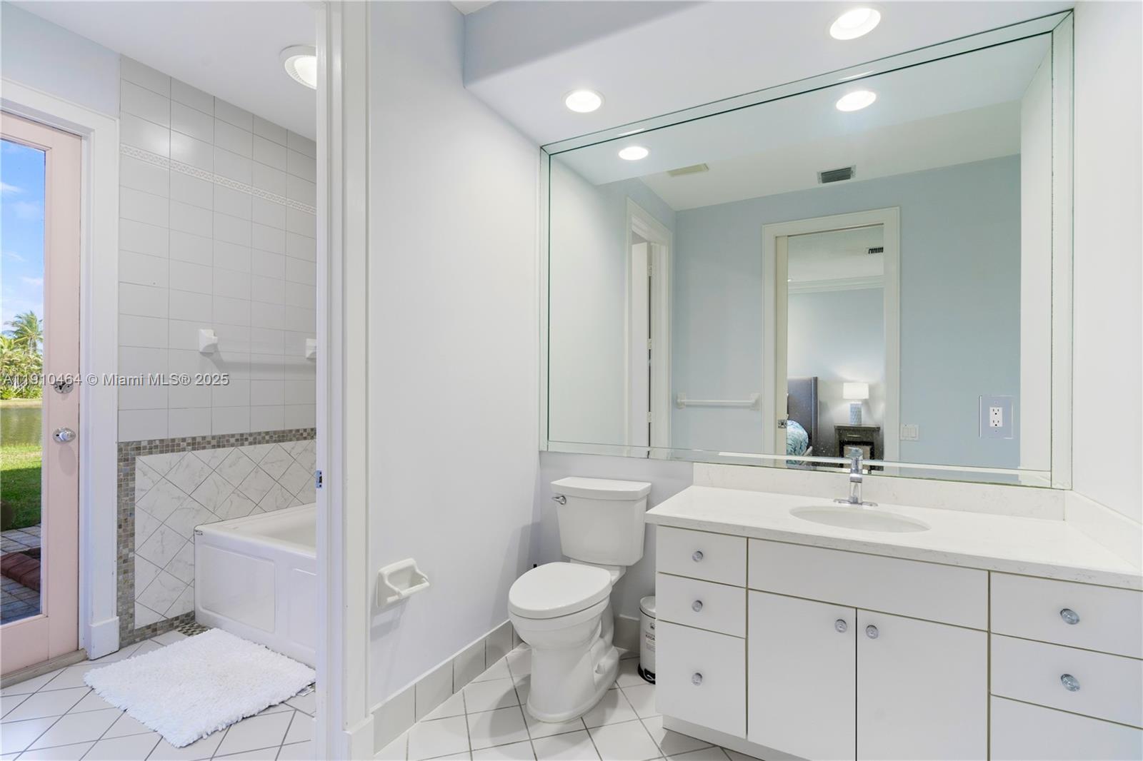 2939 Paddock Lane Weston, FL 33331 - Photo 44 of 59 a bathroom with a toilet a sink and a mirror