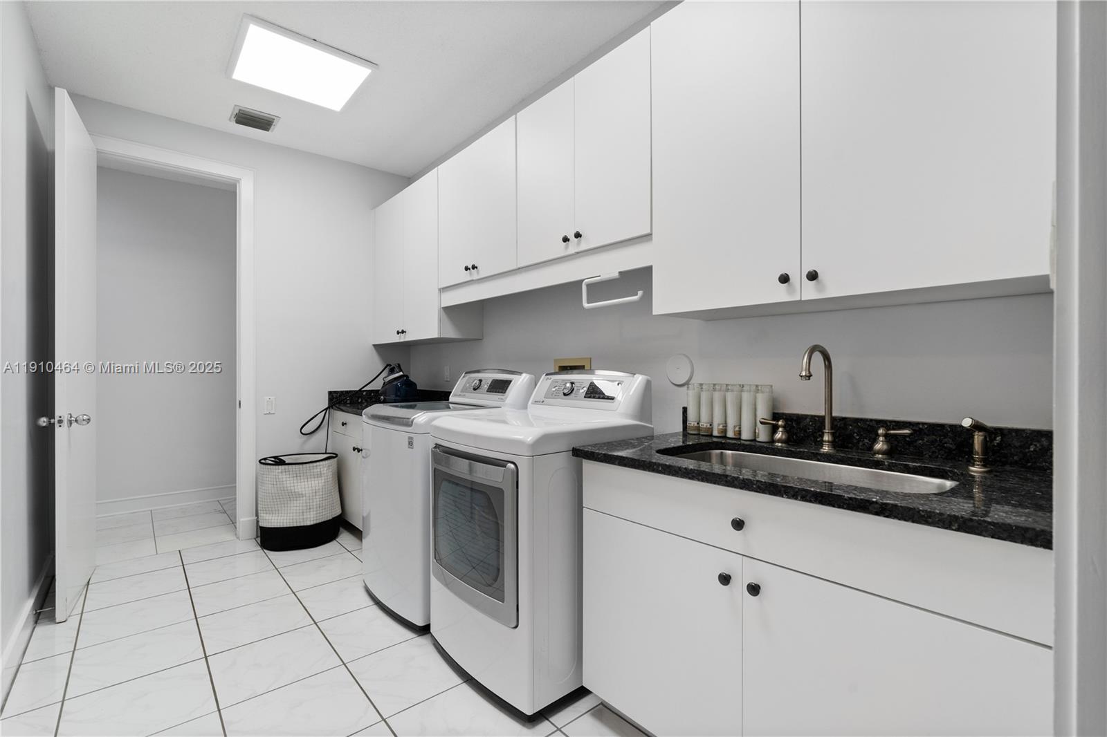 2939 Paddock Lane Weston, FL 33331 - Photo 49 of 59 a kitchen with a sink and cabinets